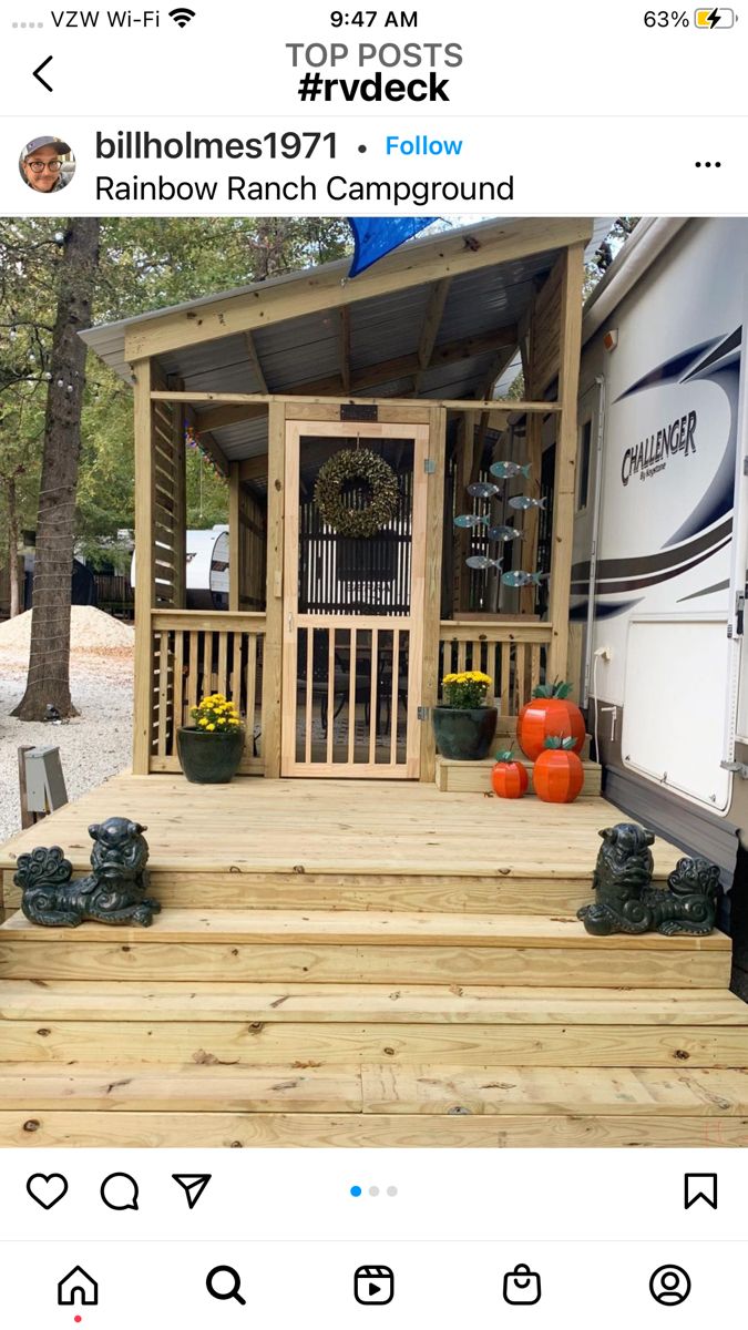 a mobile home with steps leading up to the front door and covered in wood siding