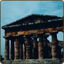 an ancient structure with many columns on the top and bottom, against a blue sky