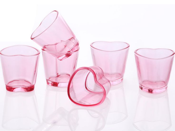 pink glass cups and glasses on a white surface