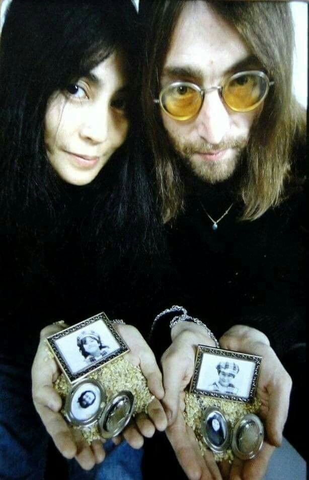 a man and woman holding up some small objects