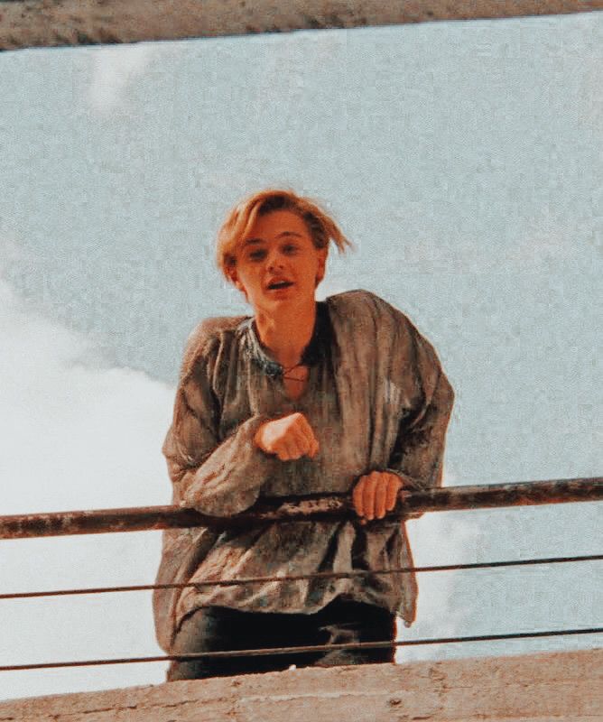 a woman standing on top of a balcony next to a railing with her hand out