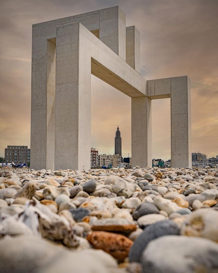 there is a very large white structure in the middle of some rocks and pebbles on the ground