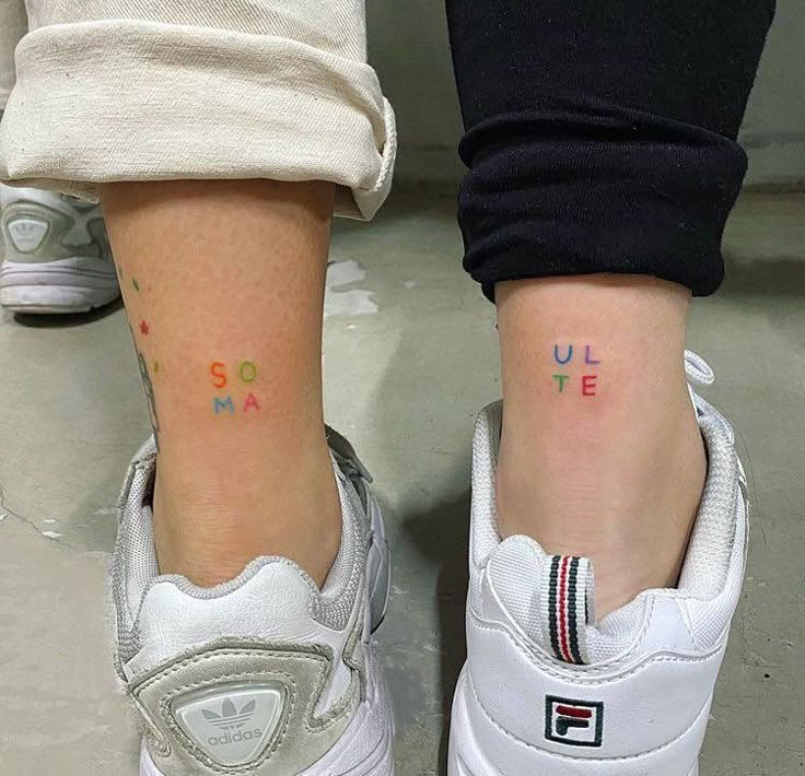 two people with matching tattoos on their legs, both showing the same name and number