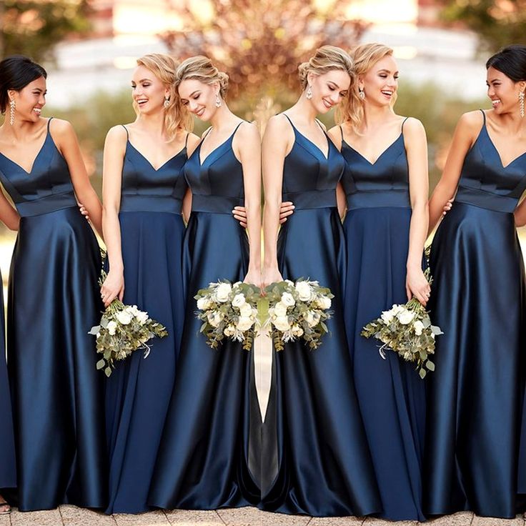 the bridesmaids are all dressed in navy blue gowns and holding bouquets