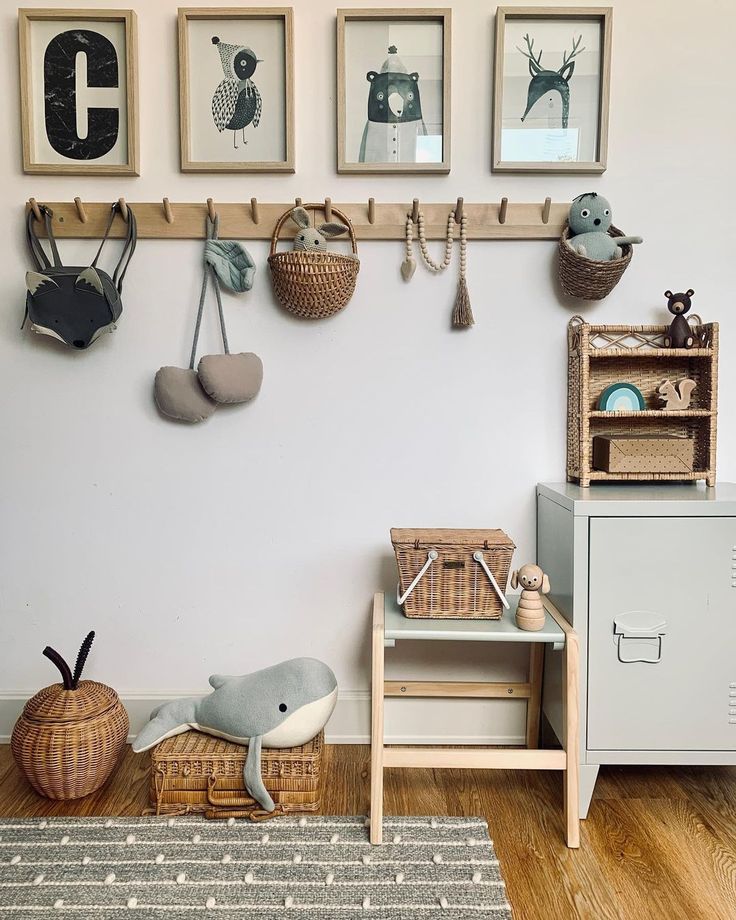 there are many pictures hanging on the wall in this child's room, including toys and stuffed animals