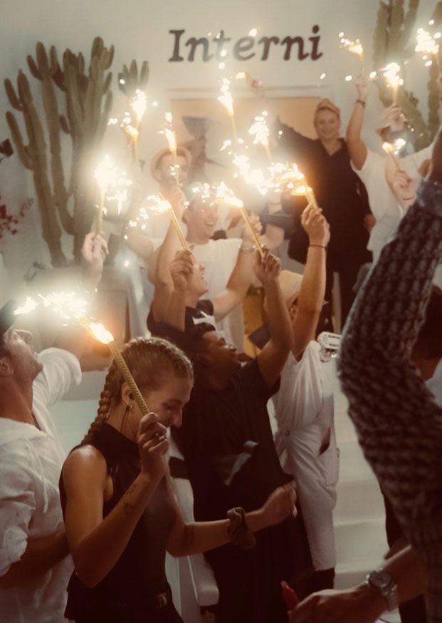 a group of people holding sparklers up in the air