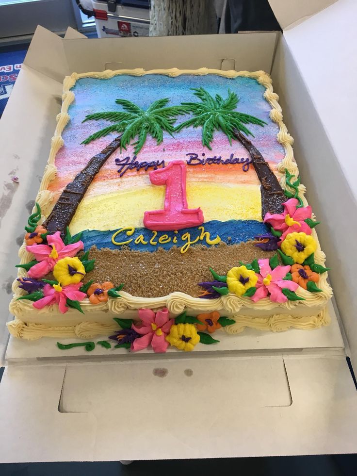 a birthday cake decorated with flowers and palm trees