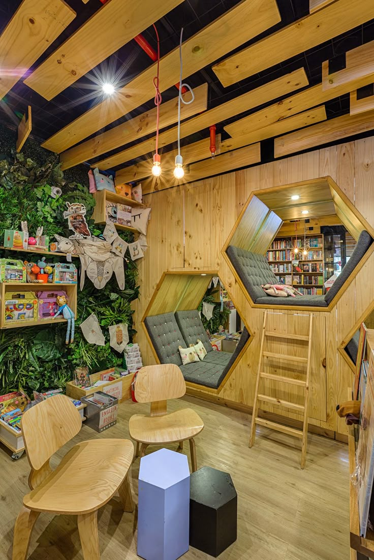 a room filled with lots of wooden furniture and bookshelves next to a green wall