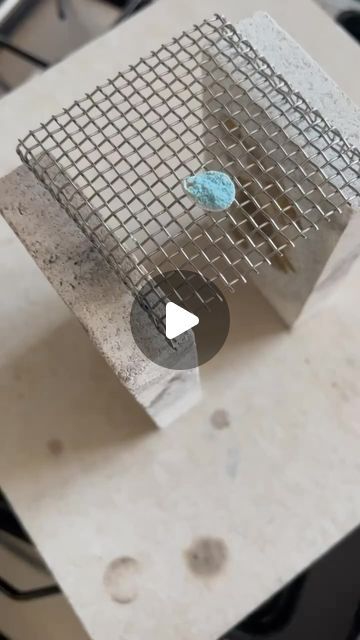 a piece of metal mesh sitting on top of a table