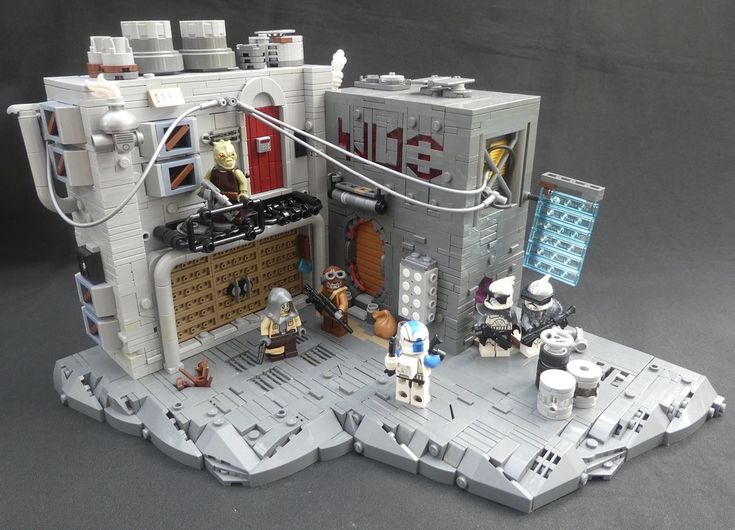 a lego star wars set is displayed on a gray surface with other toys and accessories