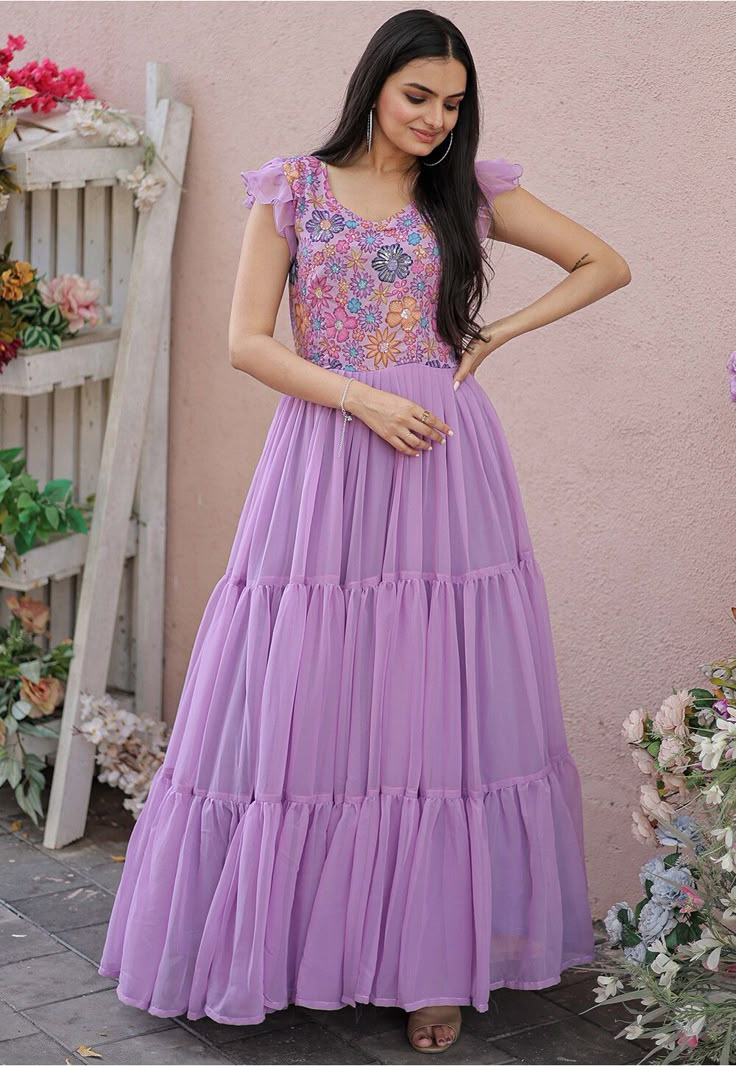 Readymade Faux Georgette Tiered Dress in Light Purple This attire is Enhanced with Resham and Sequins Work. Crafted in V Neck and Angle Sleeve Its Length is 56 inches Do note: 1.)Accessories shown in the image are for presentation purposes only and length may vary upto 2 inches. 2.)Slight variation in actual color vs. image is possible. Hands Designs For Long Frocks, Long Frock Designs For Women, Frocks Designs For Women, Long Frock Models, Long Frocks For Women, Creative Dresses, Angle Sleeve, Dress Designs For Stitching, Frock Models