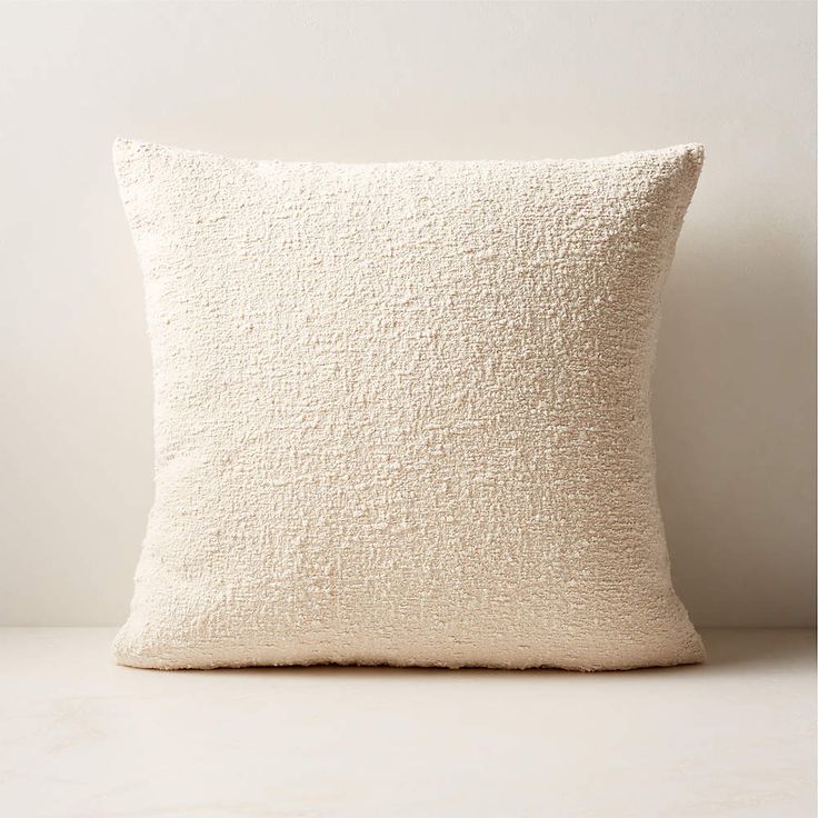 a white pillow sitting on top of a table