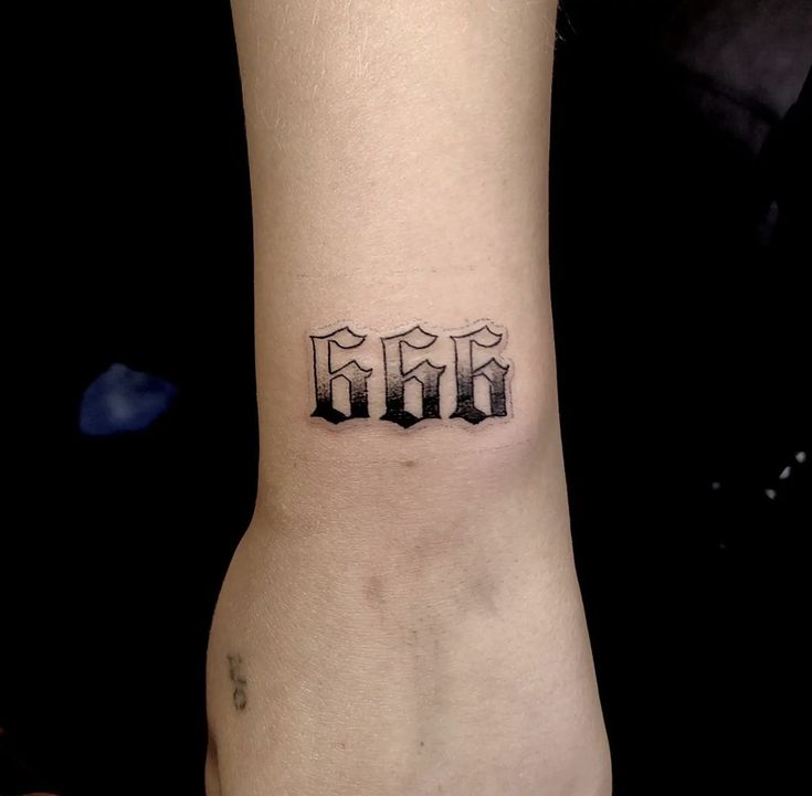 a small wrist tattoo with the word mom on it