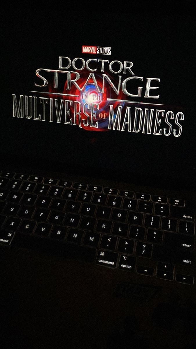 a laptop computer sitting on top of a desk with the title doctor strange multiverse madness