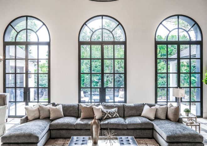 a large living room with high arched windows