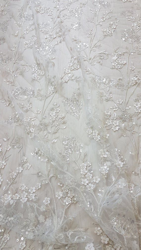 Gorgeous sparkling flower lace with beads and transparent sequins, wedding lace fabric, bridal lace, embroidery lace LL-1168 Perfect for Dress making, bridal wear, wedding gown and graduation balls. Maincolor: off-white Secondcolor: Silver Width of Tulle: 59 Inch (150cm) Width of Design: 50 Inch Beaded Lace Fabric Bridal, Luxury Rhinestone-embroidered Organza Fabric, Luxury Lace Tulle Fabric With Pearl Embroidery, Luxury Delicate Lace Embroidered Fabric, Luxury Sequin Fabric With Floral Applique For Wedding, Luxury Sequin Fabric With Intricate Embroidery For Wedding, Luxury Beaded Embroidered Fabric For Wedding, Luxury Organza Tulle Fabric With Intricate Embroidery, Luxury Embroidered White Tulle Fabric