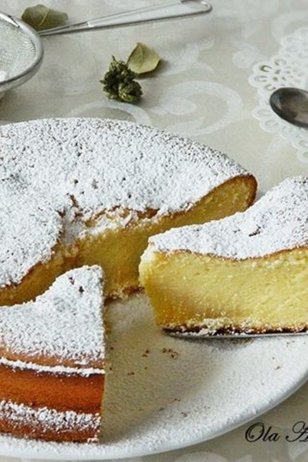 a cake on a white plate with powdered sugar