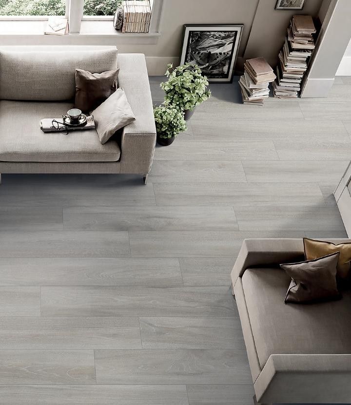 an overhead view of a living room with grey wood flooring