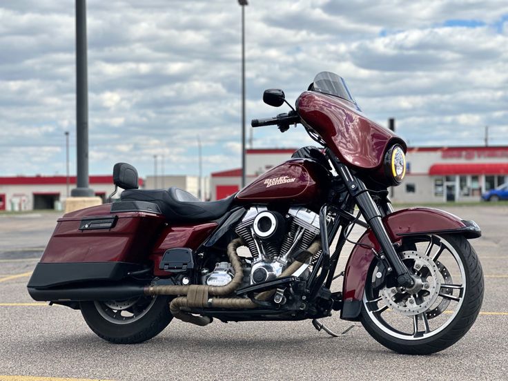 a red motorcycle parked in a parking lot