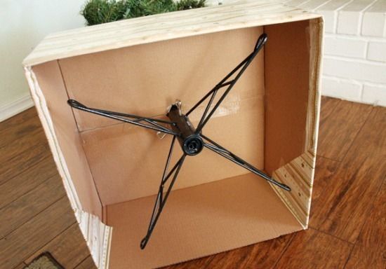 a clock made out of cardboard sitting on top of a wooden floor