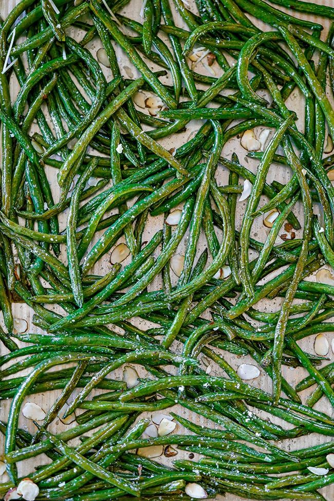 some green beans are laying on the table and ready to be cooked in the oven