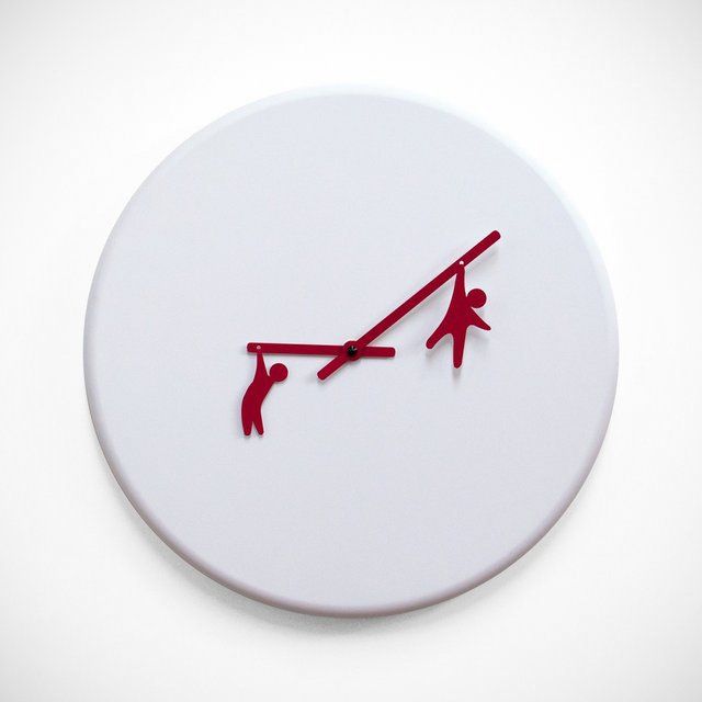 a white clock with red hands and two people on it's face, against a white background