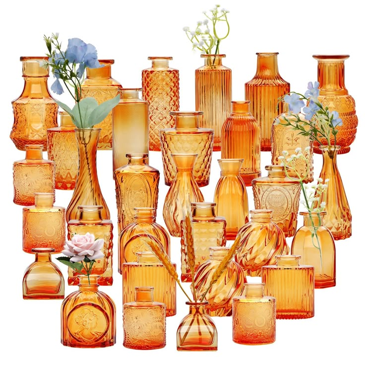 a large group of vases with flowers in them sitting next to each other on a white background