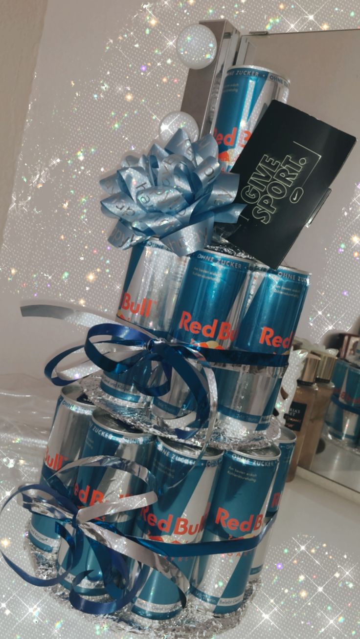 a stack of soda cans with blue ribbons