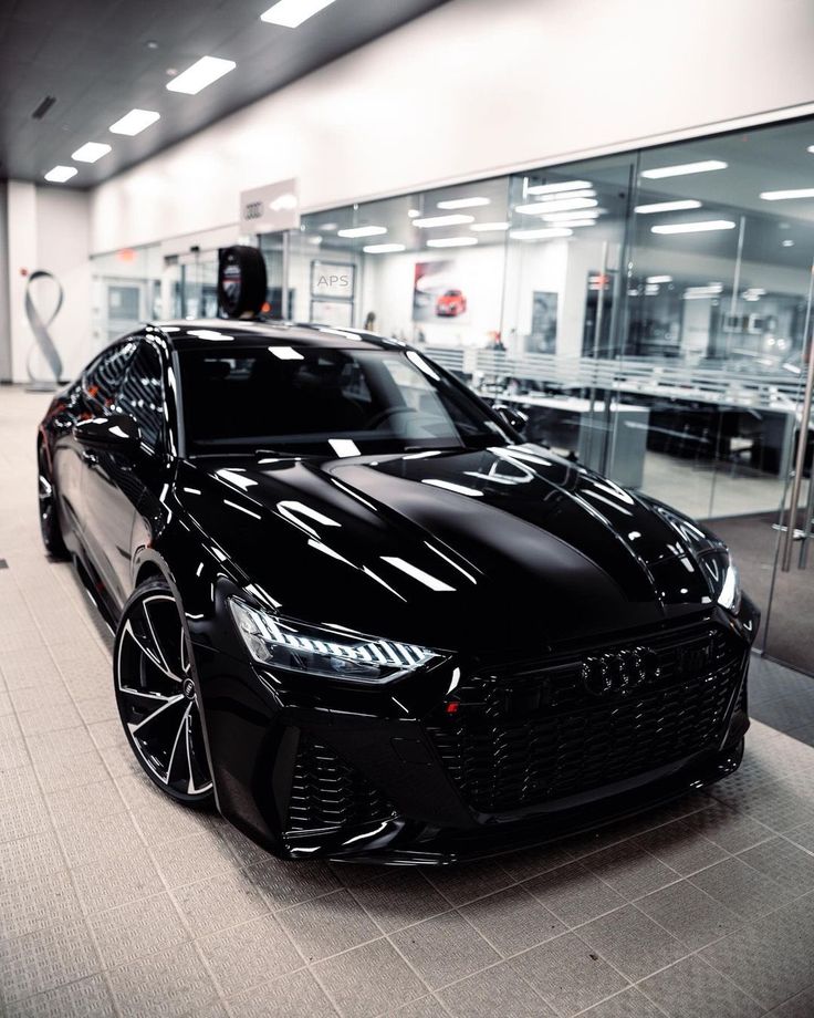 a black sports car parked in a showroom