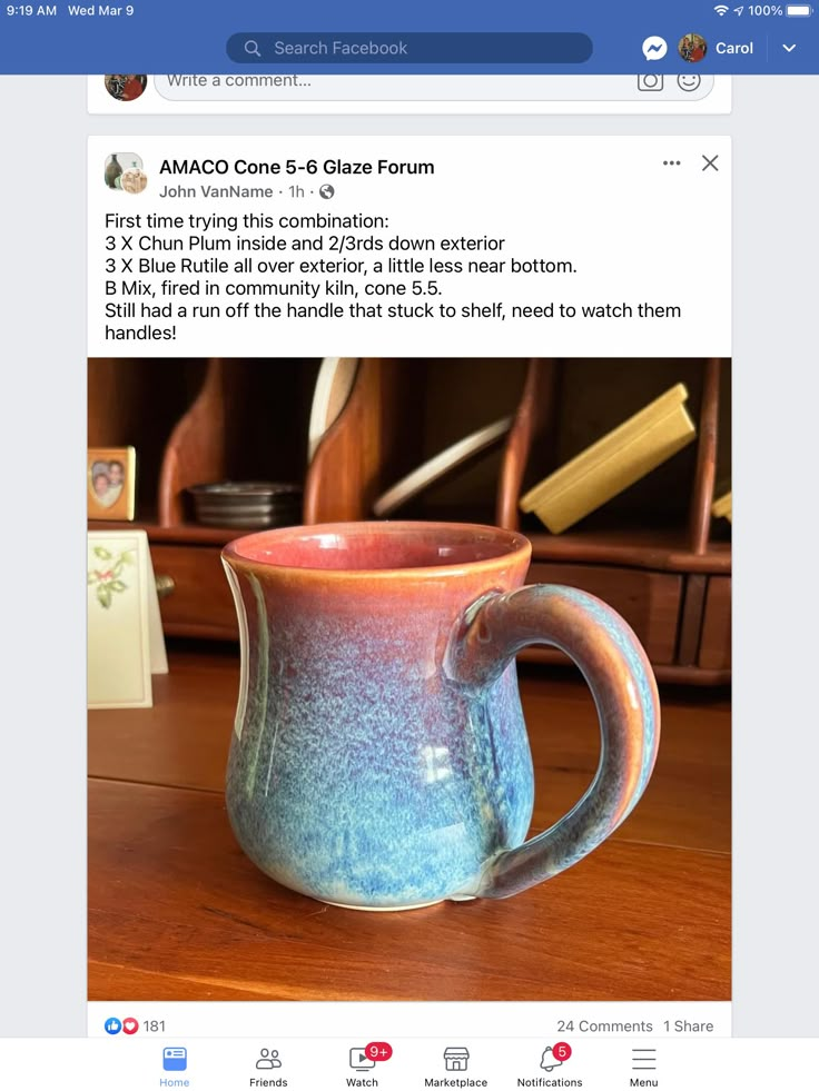 a blue and pink mug sitting on top of a wooden table