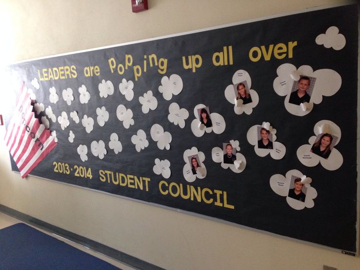 a bulletin board with pictures of people on it in a school hallway that reads leaders are going up all over 2013 student council