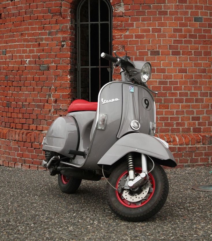 a scooter parked in front of a brick building