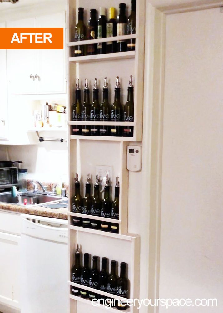 an open refrigerator filled with lots of bottles next to a stove top oven in a kitchen