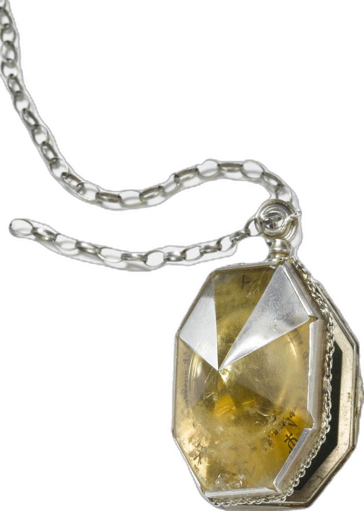 a necklace with a large yellow stone hanging from it's center chain, on a white background