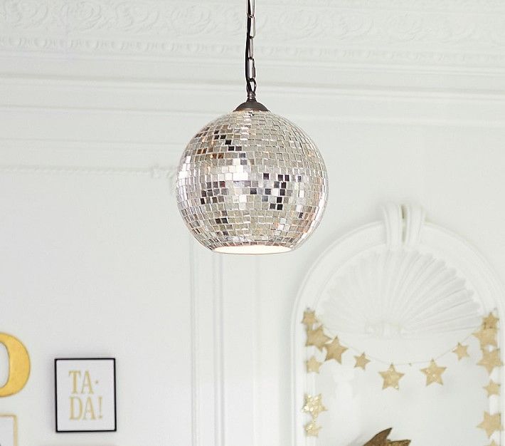 a mirror ball hanging from the ceiling in a room with white walls and gold stars