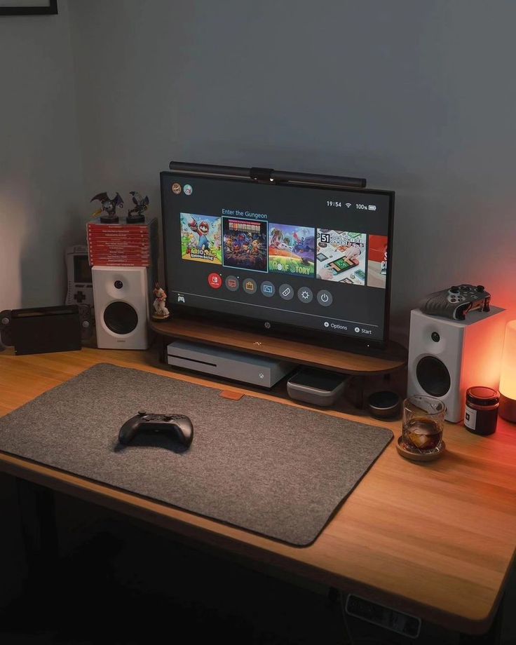 a computer monitor sitting on top of a desk next to a keyboard and mouse pad