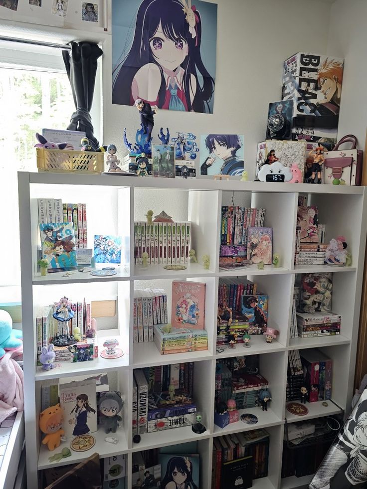 a book shelf filled with lots of books and anime pictures on top of each shelf