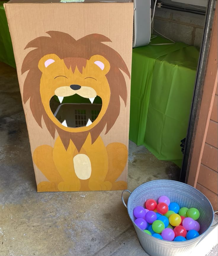 a cardboard box with an image of a lion on it next to some candy balls