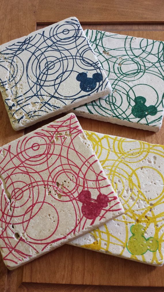 three coasters with mickey mouse designs on them