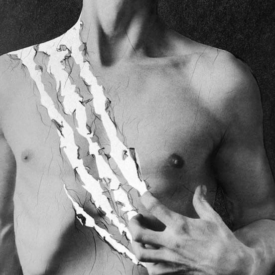 black and white photograph of a man with paper on his chest