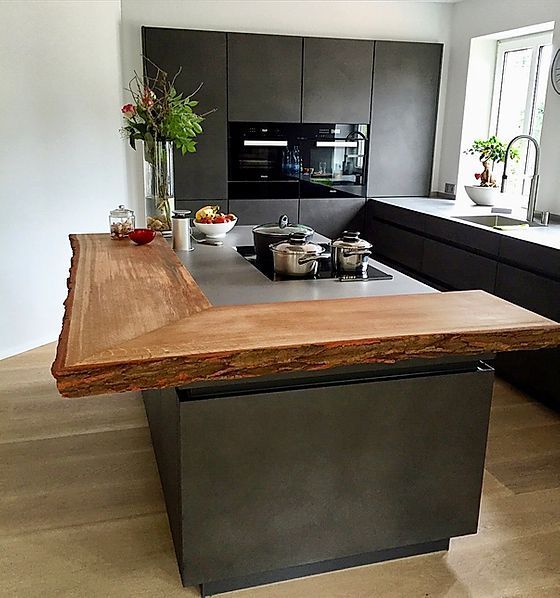 the kitchen counter is made out of wood and has an island in front of it