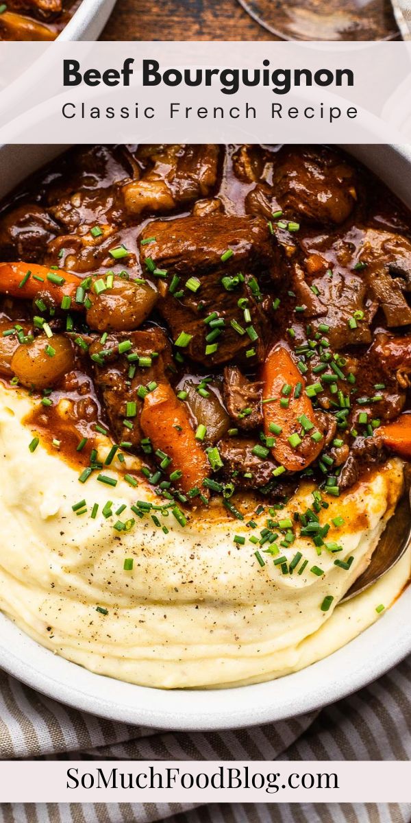 a bowl filled with mashed potatoes, beef and gravy on top of a table