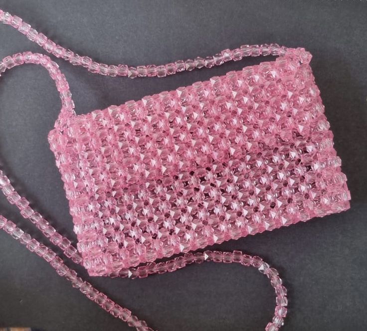 a pink handbag sitting on top of a table