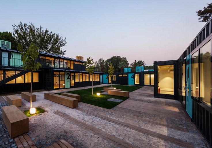 an outdoor courtyard with benches and lights