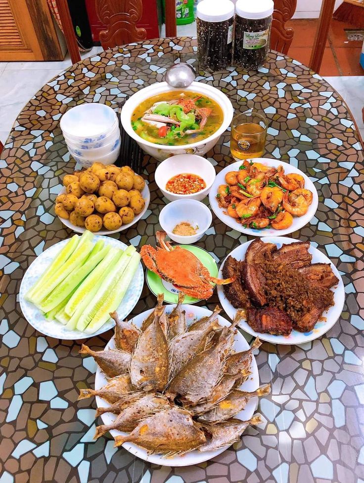 a table topped with plates and bowls filled with food