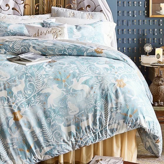 a bed with blue and white comforters in a bedroom