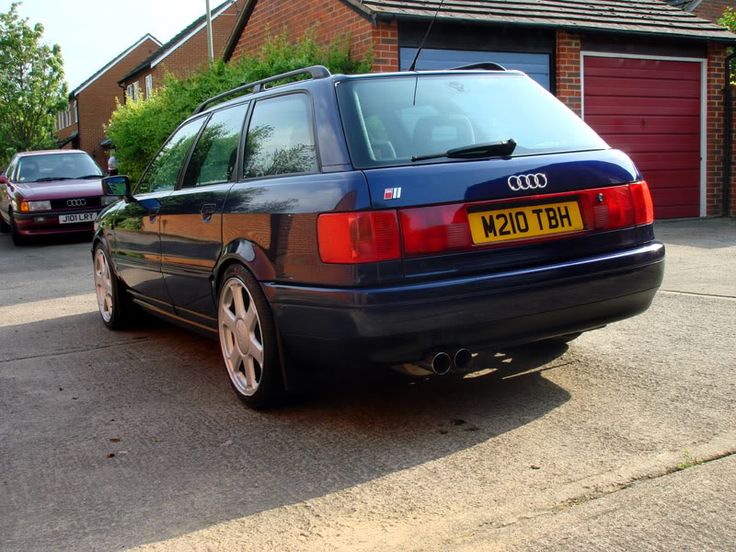 an audi car parked in front of a house next to a red fire hydrant