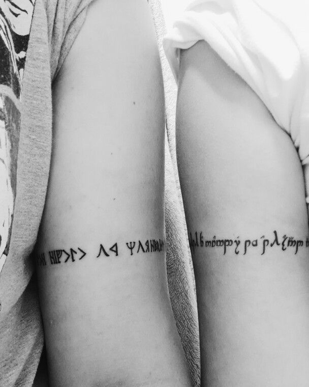 two people with tattoos on their arms that say, happy birthday and happy new year