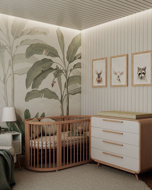 a baby's room with a crib, dresser and wallpapered walls