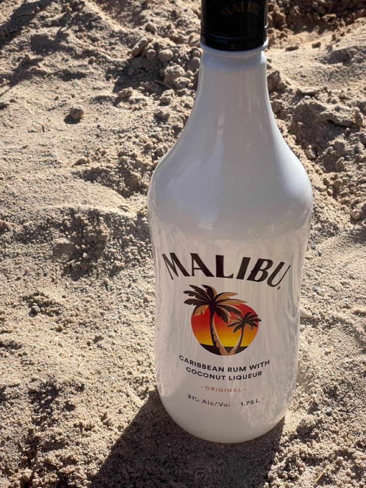 a bottle of marlbu on the beach